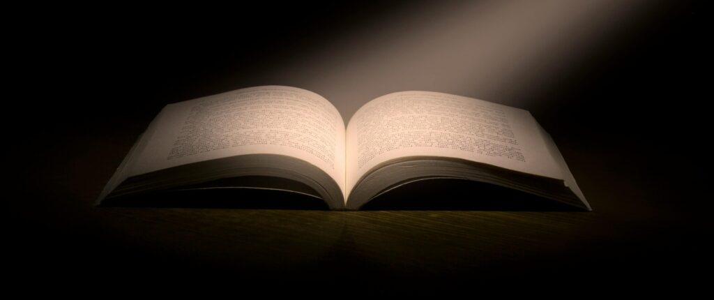 A captivating image of an open book under a dramatic spotlight, symbolizing knowledge.